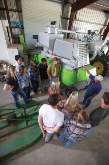 a group of people standing around a machine.